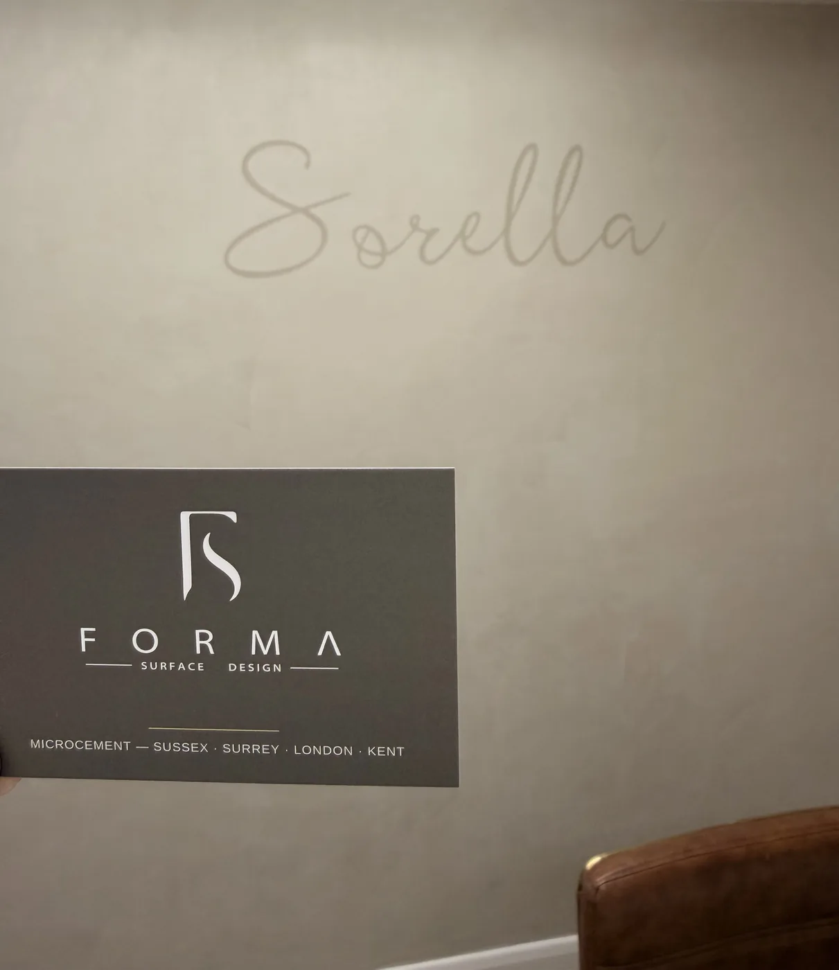 Sorella wordmark and branded signage on a finished commercial microcement wall