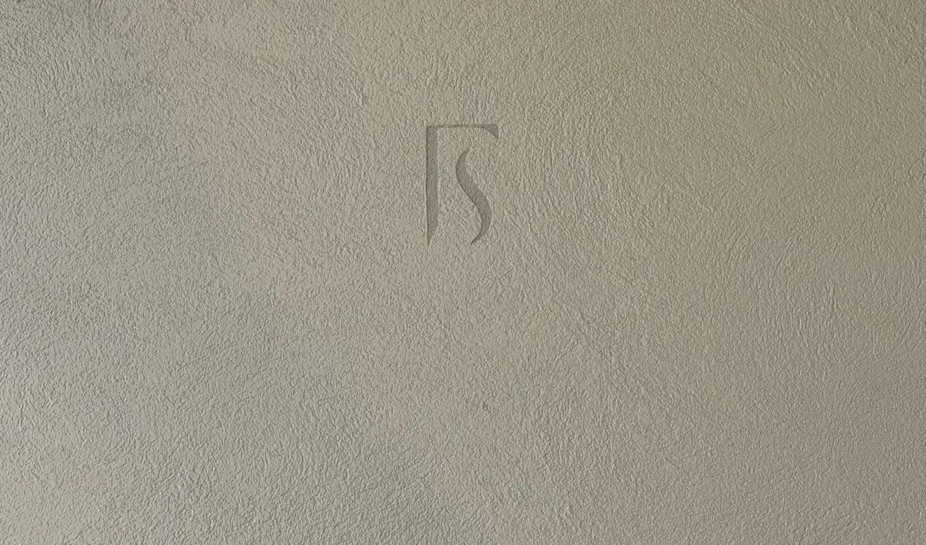 Forma FS monogram set into a textured microcement wall