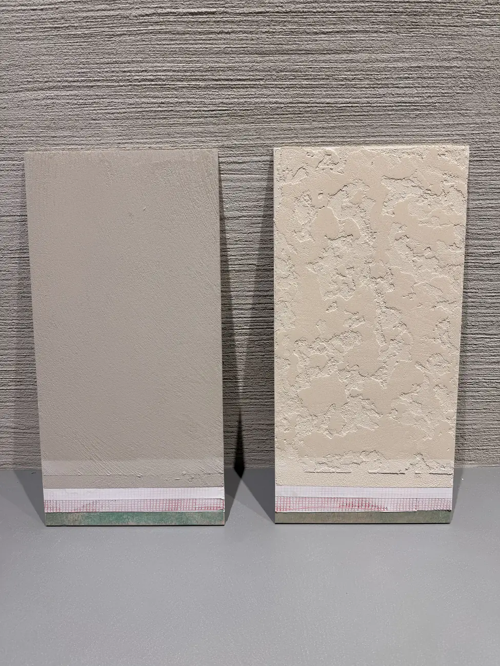 Smooth and heavily textured Oltre microcement sample boards side by side, with the build up layers visible at the base