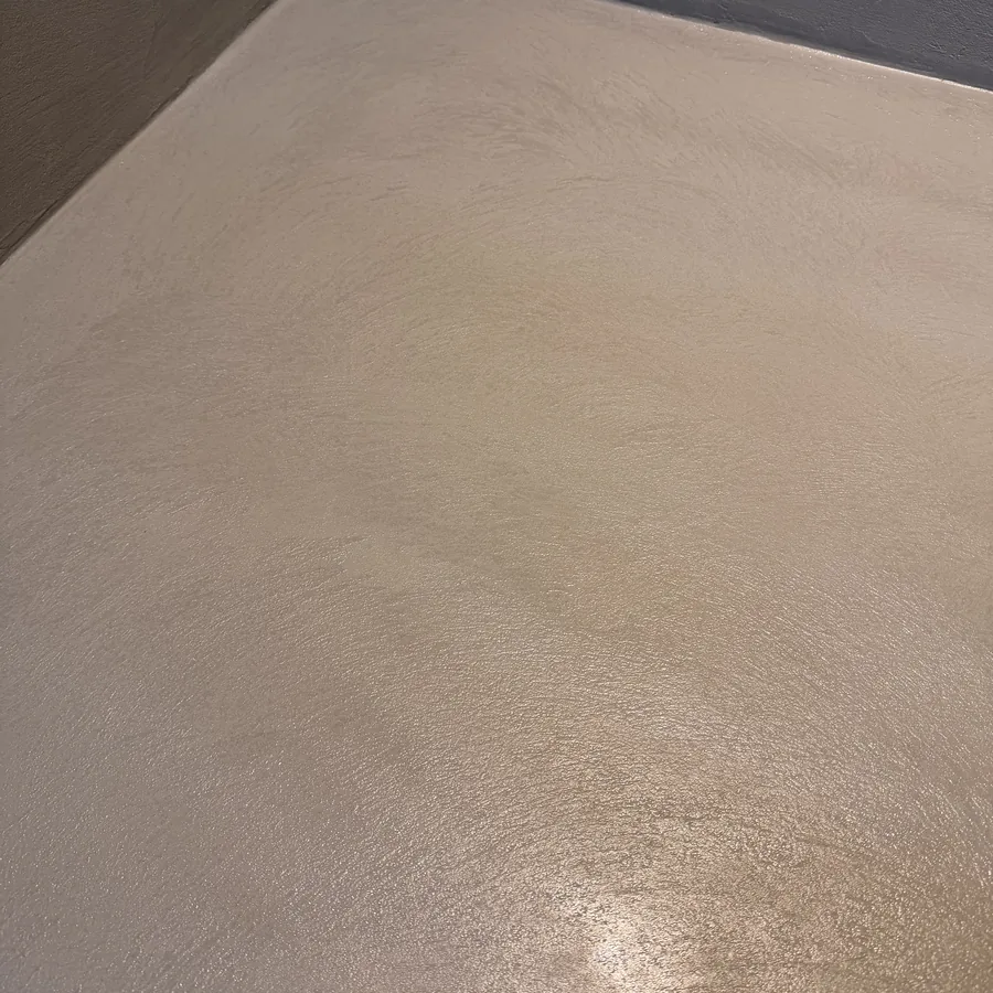 Smooth, floated Oltre microcement floor finish in raking light