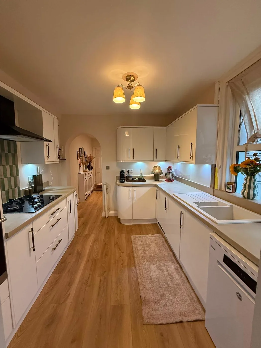 Microcement kitchen worktop finished to match the surrounding units, running past the sink